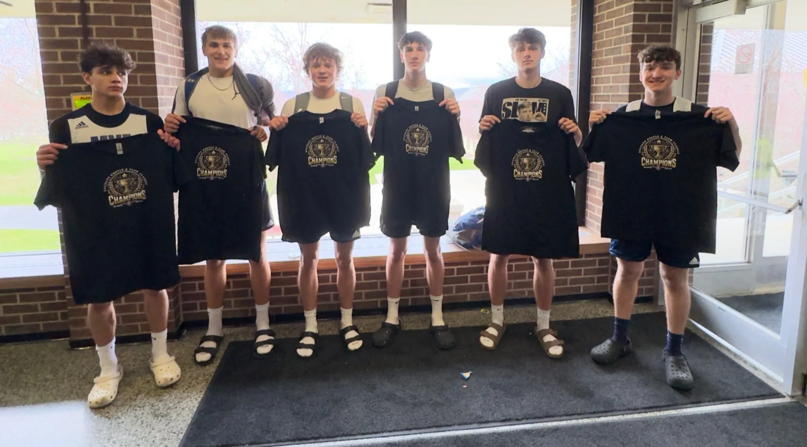 Tournament champions with their shirts