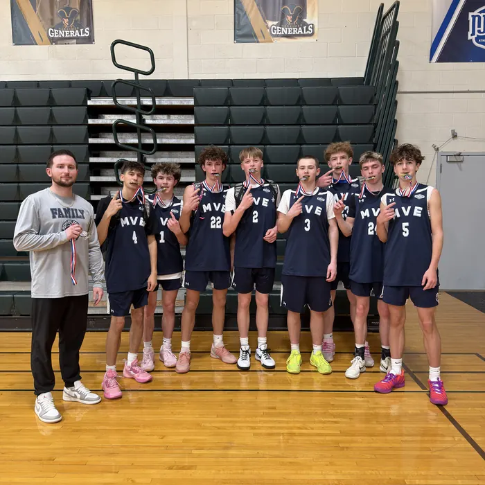 MVE team with a championship medal after a tournament win