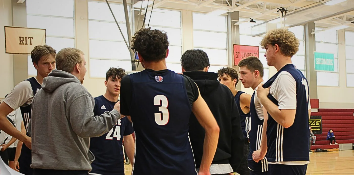 MVE coach with players in a huddle