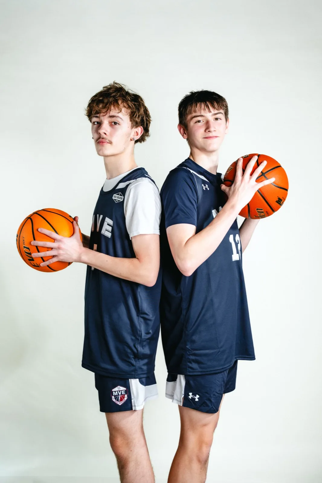 MVE teammates posing with basketballs at media day