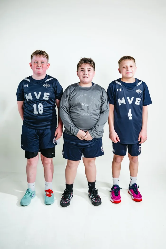 Three MVE teammates standing shoulder to shoulder at 2026 Media Day