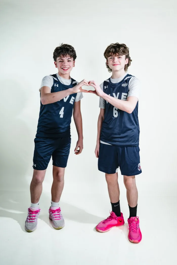 Two MVE teammates making a heart shape with their hands at 2026 Media Day