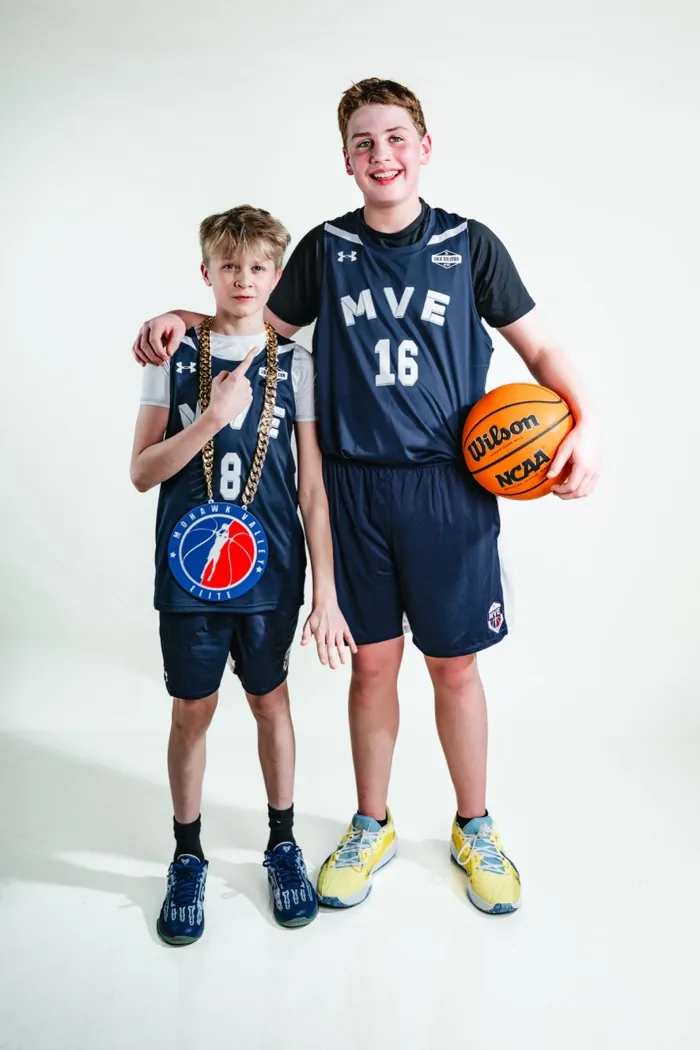 Two MVE teammates side by side, the shorter one wearing the player-of-the-game chain, at 2026 Media Day