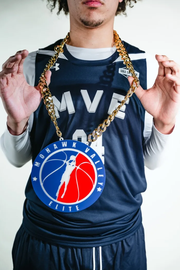MVE player wearing the chain, arms raised, at 2026 Media Day