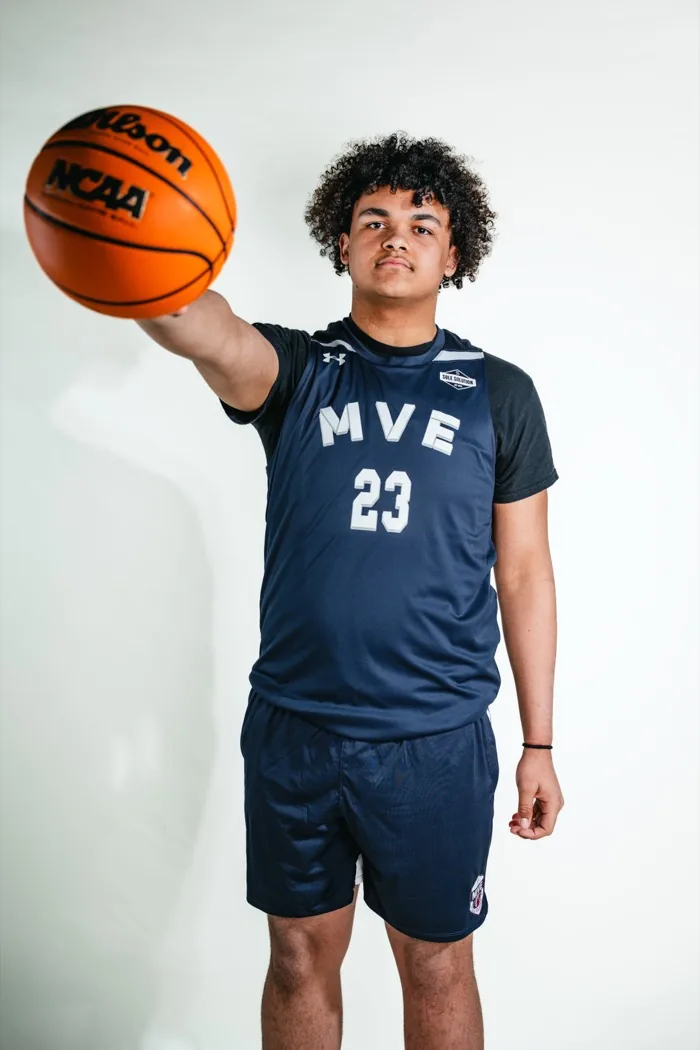 MVE player holding a basketball out on an extended arm at 2026 Media Day