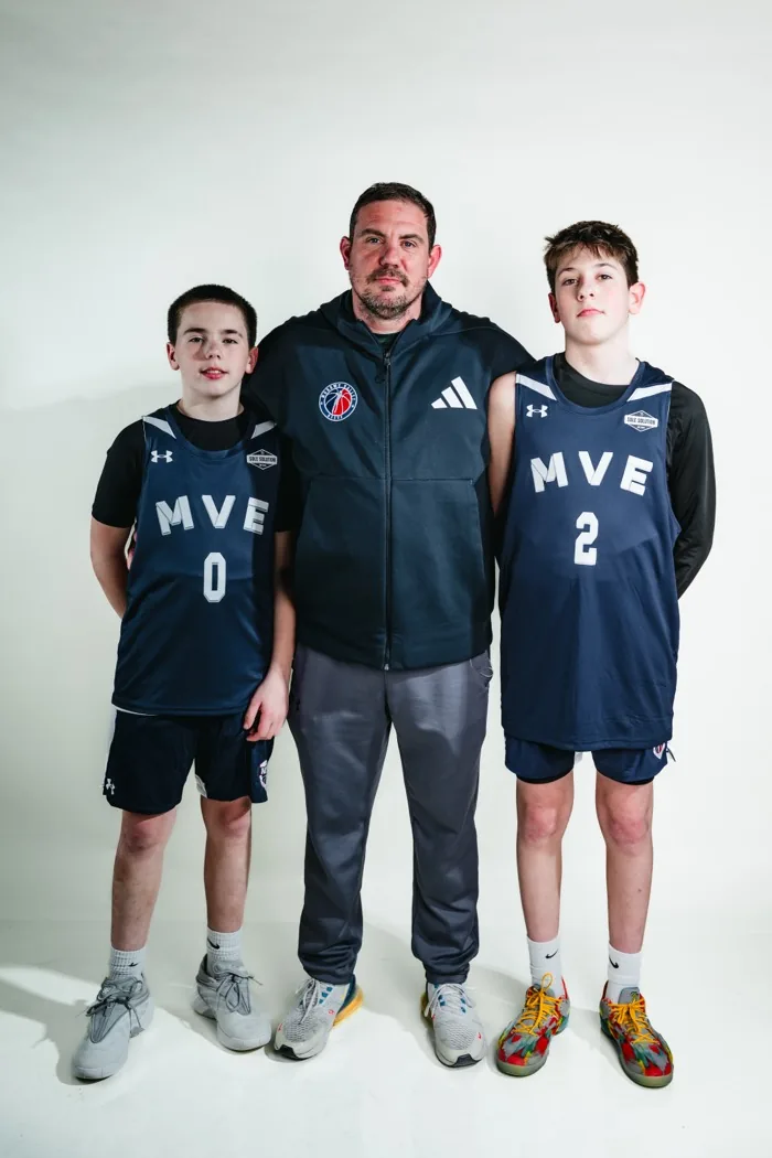 An MVE coach with two of his players at 2026 Media Day