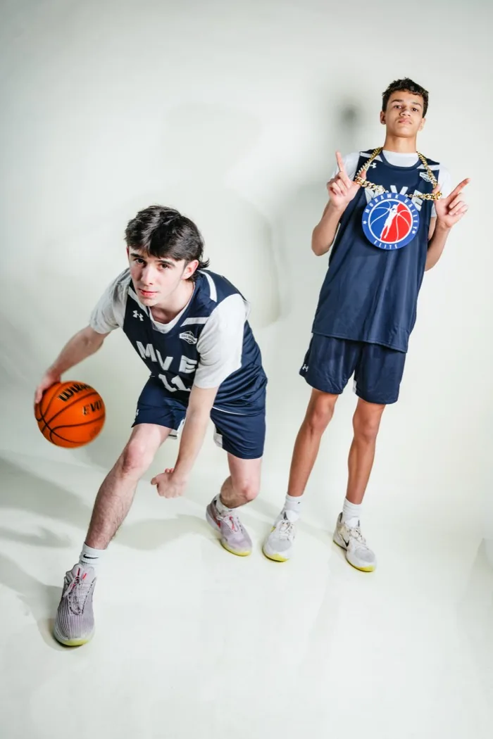 Two MVE players at 2026 Media Day, one driving with the ball while the other poses in the chain